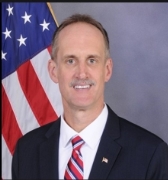 A person in a suit and tie

Description automatically generated