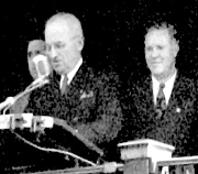 A group of men standing at a podium

Description automatically generated